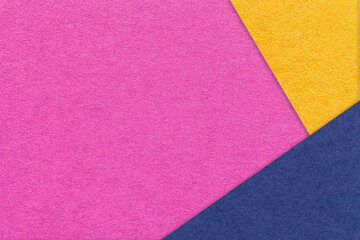 Fototapeta premium Texture of craft magenta color paper background with navy blue and yellow border. Vintage abstract purple cardboard.