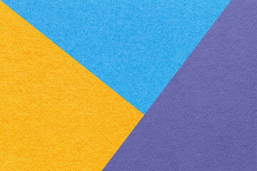 Fototapeta na wymiar Texture of craft blue, yellow and violet shade color paper background, macro. Structure of vintage abstract cardboard
