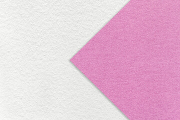 Texture of white paper background, half two colors with lilac and pink arrow, macro. Craft purple...