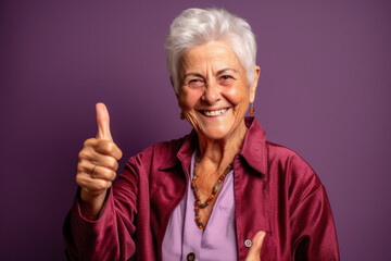 Studio portrait of a happy senior woman with thumbs up positive hand gesture. Generative ai