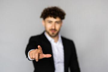 Businessman point finger at invisible screen, hand pushing touch screen. Business man pressing virtual button over grey