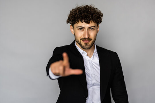 Businessman point finger at invisible screen, hand pushing touch screen. Business man pressing virtual button over grey