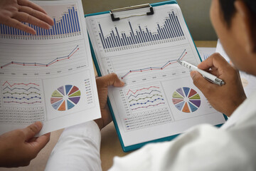 Business people group meeting. Teamwork with business people analysis financial graphs and charts on desk at meeting room.