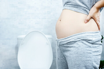 woman with big abdomen in the toilet have problems with chronic constipation, lazy bowel syndrome,...