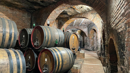Many big wine barrels stored in the  cellar in Montepulciano, Italy