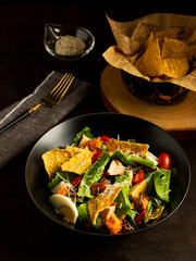 Healthy delicious egg crispy caesar salad with parmesan cheese, dressing, fork and croutons.