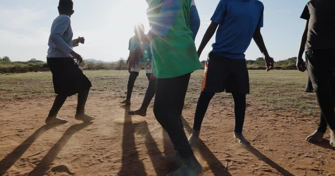 Poverty. Slow motion. Poor Black African children playing soccer in a township slum