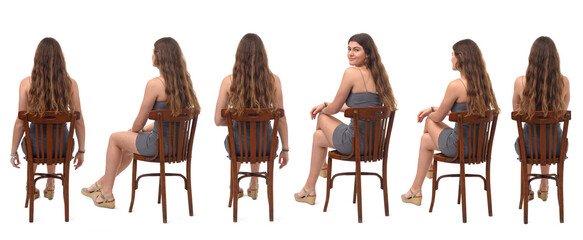back viw of group of same young gril sitting on chair and turned and looking at camera  on white...