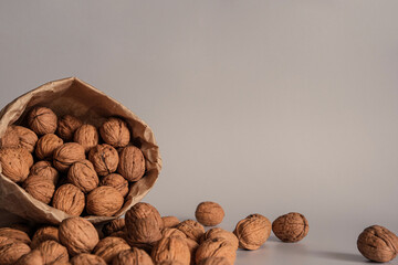 Walnut in a paper bag on a white background. Natural ingredient. Close-up, shopping grocery concept, nuts delivery. Zero Waste Food Shopping. Copy space