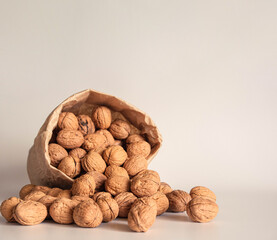Walnut in a paper bag on a white background. Natural ingredient. Close-up, shopping grocery concept, nuts delivery. Zero Waste Food Shopping. Copy space