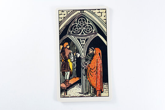 Madrid, Spain - May 22, 2023: Tarot cards, Rider Waite tarot cards, the three of pentacles vintage card in the foreground.
