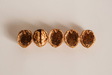 Shelled and unshelled walnuts. Being smart vs. stupid. Accurate solutions lead to success, efficiency, smartness, cleverness let you avoid complications and hard work.