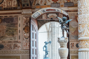 Sculpture of cupid with dolphin in the inside contryyard of a Palazzo Vecchio palace in the old...