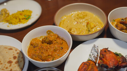 Happy Muslim family start eating on break fasting Ramadan iftar family dinner. Parent and child dinner together on dining table. Celebration end of Eid al-Fitr togetherness, Hari Raya family reunion.