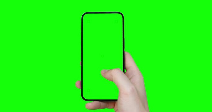 A man's hand holds a smartphone with an empty green screen with tracking markers and scrolls through the app content using his thumb - a template for browsing app content. Chroma key included