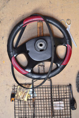 car steering wheel hanging on a red wooden wall