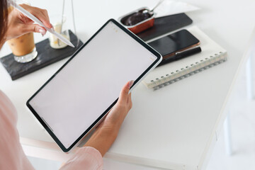 Young Asian businesswoman using laptop and notebook computers to work through internet to collect and organize investment documents. young businesswoman concept using technology to help investment