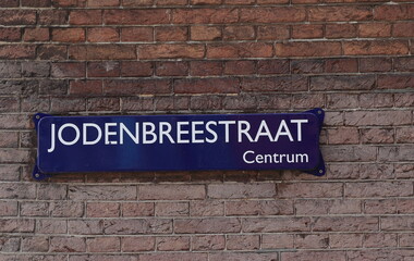 Fototapeta premium Amsterdam Jodenbreestraat Street Sign on a Brick Wall Close Up, Netherlands.