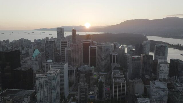 Flying over downtown Vancouver toward the harbour at sunset