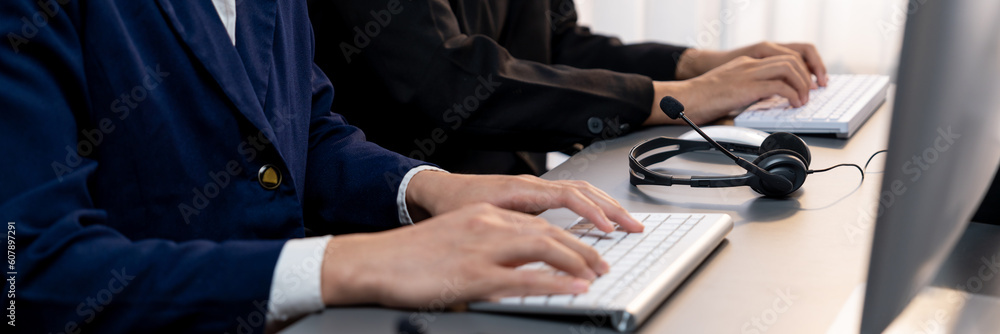 Aufkleber panorama focus headset on call center workspace desk with blur background of operator team or telesa