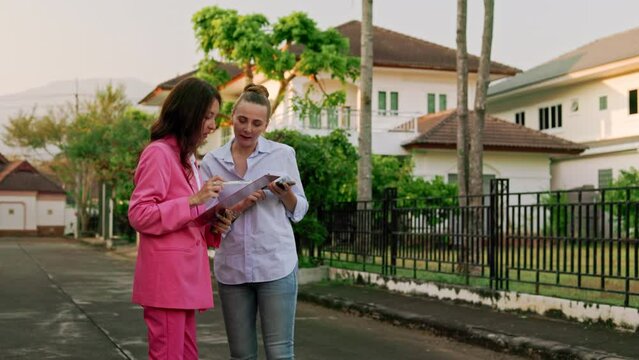 In an exclusive village, a real estate agent and her client chatted amiably while examining the stunning homes before them.