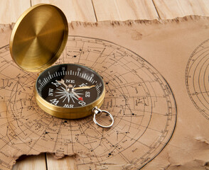 old maps and compass on a wooden table
