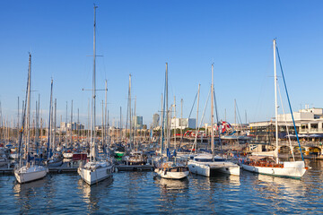 Fototapeta na wymiar Sailing yachts and pleasure boats are moored in Barcelona port