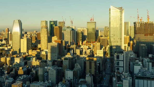 Time Lapse of the morning sun shining on the densely packed buildings of Tokyo Japan