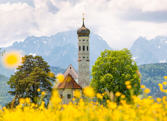 Catholic church in Bavaria St. Coloman. View against the backdrop of the Alpine mountains