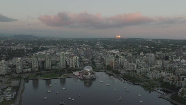 The dome of Science World reflects the setting sun in Vancouver