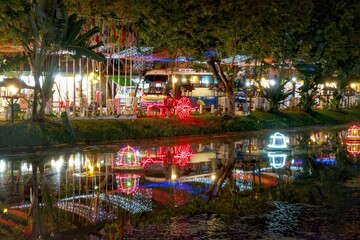 Obraz premium Decorative street lights cast their reflections on the surface of the muddy river waters flowing through Siem Reap.