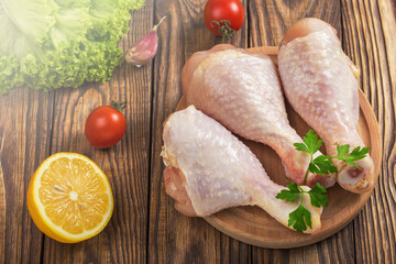 raw chicken legs and marinade ingredients on a kitchen board