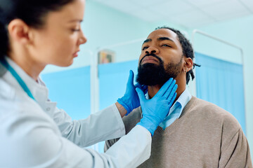 Black man having throat exam at doctor's office.
