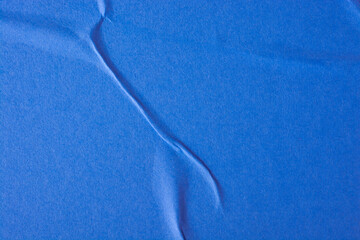 Abstract background of a blue sheet of paper with folds.