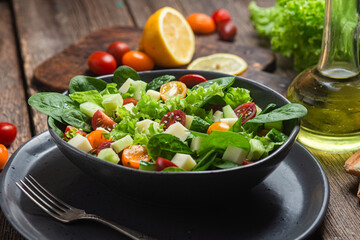 Salad of spinach, cherry tomatoes and cheese in a plate