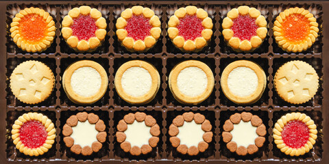Texture close-up, mix cookies in box. round biscuit cookies with various fillings. Packing cookies