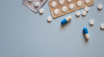 pills and pill packs on a blue background, medication, medical workers day, medical care, banner...
