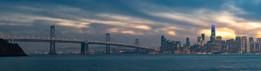 Fototapeta na wymiar Oakland Bay Bridge and Downtown San Francisco at Sunset Panorama