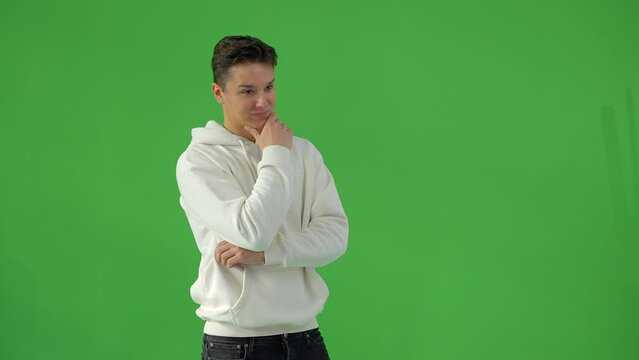 Young handsome male model posing for the camera in a studio - greenscreen shot - people photography