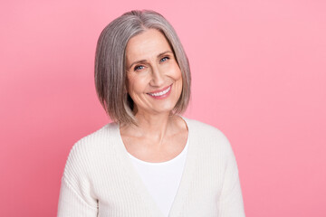 Photo of sweet cheerful aged person beaming smile good mood empty space isolated on pink color...