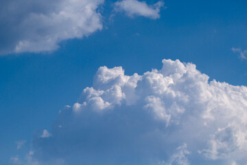 Naklejka na ściany i meble Blue sky with white puffy fluffy clouds, horizontal natural background