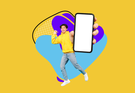 Cool App. Cheerful Asian Teen Guy Demonstrating Big Blank Smartphone At Camera