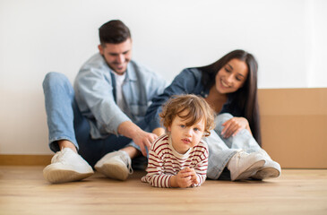Happy Family Of Three With Little Kid Posing Together On Moving Day