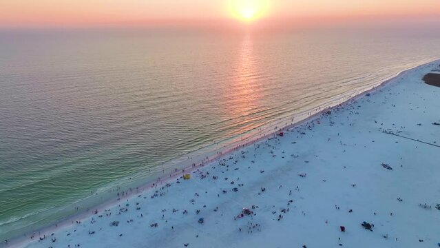 Aerial view of Siesta Key beach in Sarasota, USA. Many people enjoing vacation time swimming in gulf water and relaxing on warm Florida sun at sunset