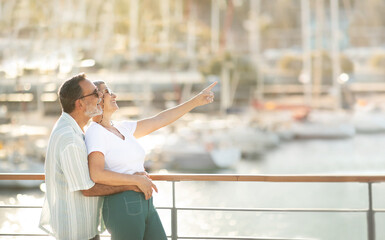 Spouses Looking At Yachts In Marina, Pointing Finger Aside Outside
