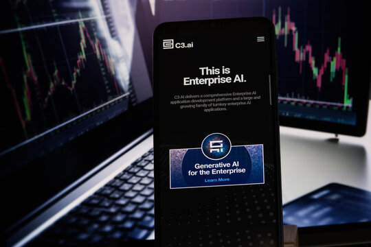 C3.ai company website on a smartphone with the blurred chart on background, stock image, USA - May 30, 2023