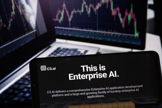 C3.ai company website on a smartphone with the blurred chart on background, stock image, USA - May 30, 2023