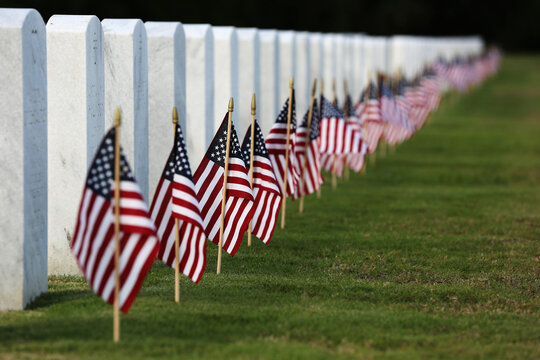 Memorial Day flags placed at headstones of American veterans who are buried at National Cemetery 