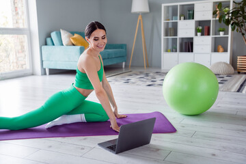 Photo of adorable sexy girl dressed sportive suit watching internet yoga lesson modern device indoors house home