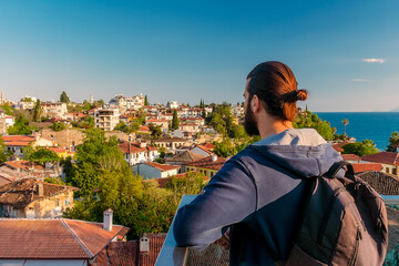 A man from an observation deck looks at the old town of Kaleiçi in the Turkish city of Antalya. A man looks at old houses in the popular tourist area of Antalya.